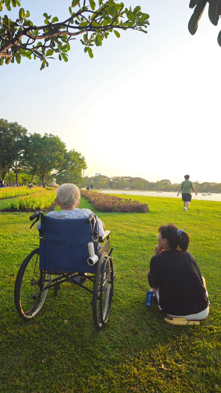 A caregiver holding hands with a senior client